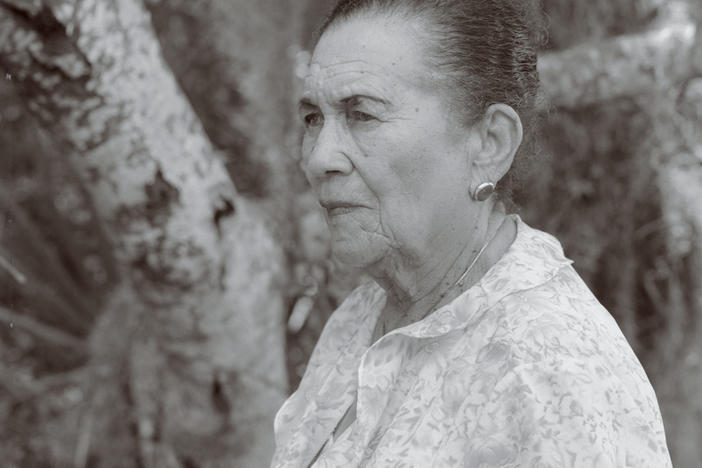 Ella Augusta Johnson Dinkins, posing in a garden, one of her favorite places.