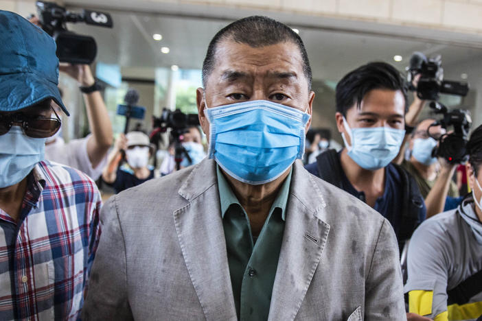 Hong Kong media mogul Jimmy Lai, seen here before a court hearing in September, has been formally charged under China's controversial new national security law.