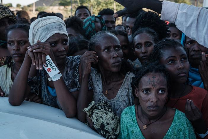 Ethiopians wait for food distribution in front of a warehouse at Um Raquba refugee camp in Gedaref, eastern Sudan, on Dec. 1.