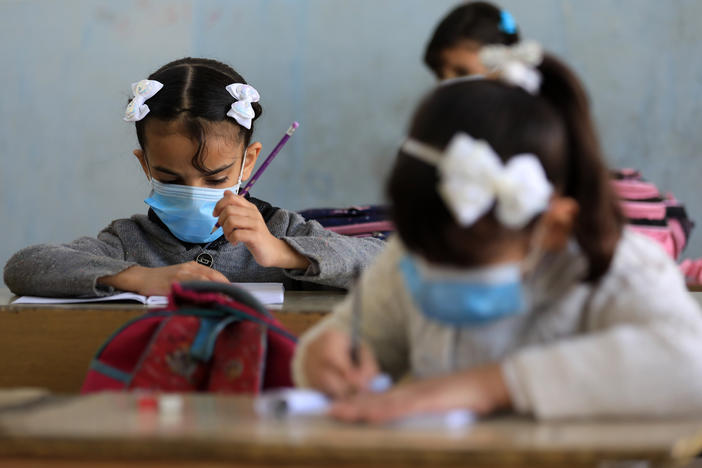 Students wear masks at a school in Baghdad.