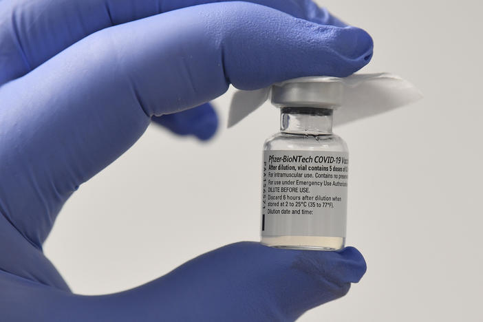A staff member at a health center displays a vial of the Pfizer-BioNTech COVID-19 vaccine this week in Cardiff, Wales.