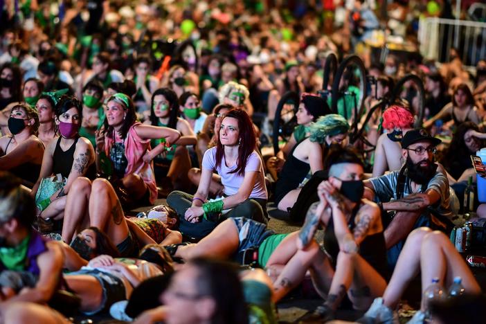 Demonstrators wait with green headscarves — the symbol of abortion rights activists — outside the Argentine Congress in Buenos Aires, where lawmakers endorsed a bill to legalize abortion