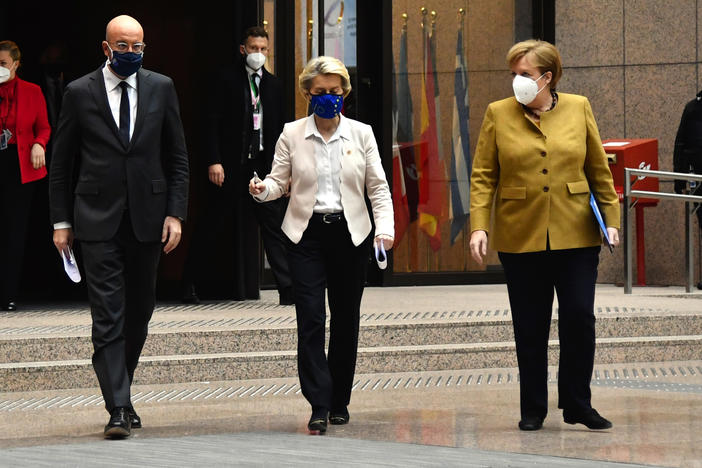 Charles Michel, president of the European Council (left); Ursula von der Leyen, president of the European Commission (center); and Angela Merkel, Germany's chancellor, wear protective face masks as they walk to a news conference at a European Union leaders summit Friday in Brussels.