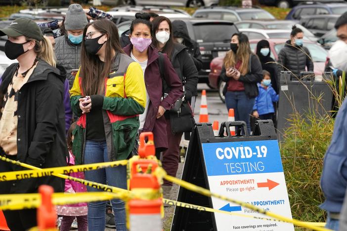 People line up to be tested for the coronavirus at a free testing site Wednesday, Nov. 18 in Seattle.