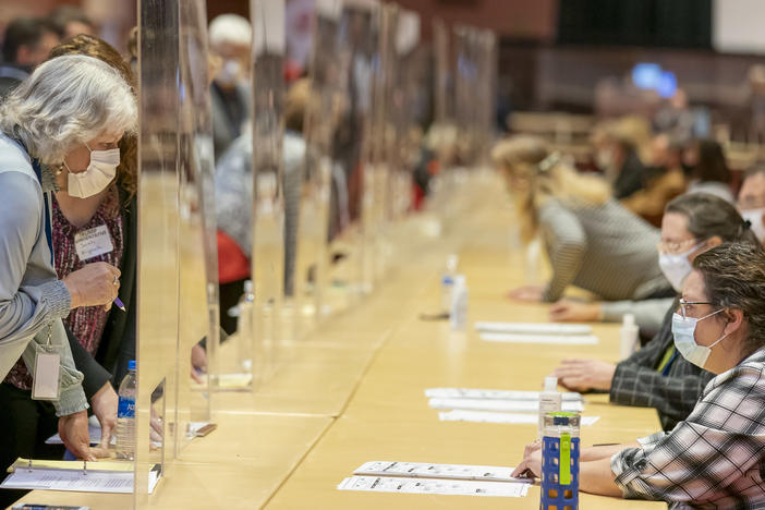 Representatives for President Trump (left) review ballots Nov. 20 in Madison, Wis., during the recount vote in Dane County. A state judge on Friday rejected a Trump campaign attempt to challenge the voting process in Dane and Milwaukee counties.