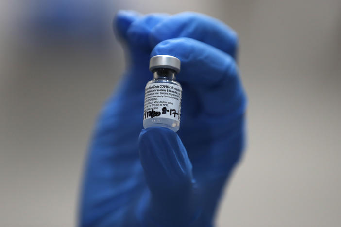 A nurse holds a vial of the COVID-19 vaccine produced by Pfizer and BioNTech, in London earlier this week. Food and Drug Administration officials in the U.S. sought to reassure the public about the vaccine Saturday after authorizing it for emergency use.