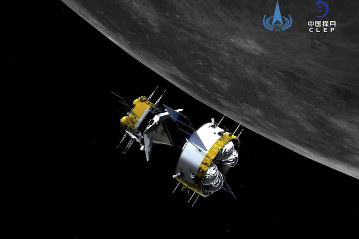 This graphic simulation image provided by China National Space Administration shows the orbiter and returner combination of China's Chang'e-5 probe after its separation from the ascender. The probe is on its way back to Earth, bearing gifts.