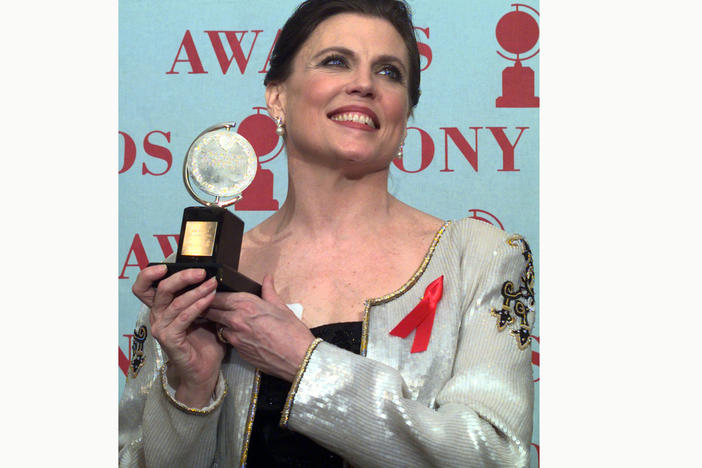 Ann Reinking, pictured holding her Tony Award for best choreography for the musical <em>Chicago</em> in 1997, died on Saturday, her family said in a statement.