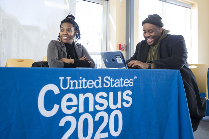 Chris Worrell jokes with Teresa Jefferson while applying for a 2020 census job in Boston in February before the COVID-19 pandemic. Based on government records, the Census Bureau estimates the U.S. population has grown by as much as 8.7% since 2010.