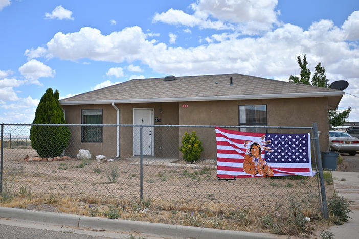 An American flag with an image of a Native American on it in To'Hajiilee Indian Reservation in New Mexico. In California, a vaccine allocation committee is considering taking historical injustice into account in advance of a statewide rollout.