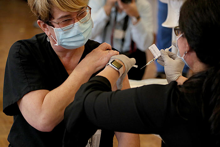 Respiratory care specialist Denise A. Beretta gets her COVID-19 vaccine Monday at Rhode Island Hospital in Providence, R.I.