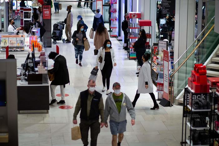 Shoppers walk through Macy's in New York on Black Friday last month. Retail sales declined 1.1% in November, according to the Commerce Department.