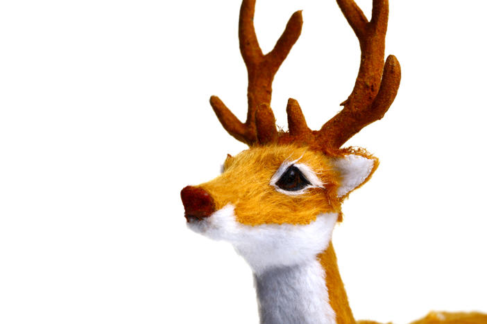 A toy reindeer is shown on a white background. Radio stations, looking to boost ratings and provide comfort in a pandemic-marred year, started playing songs as early as July. And listeners loved it.