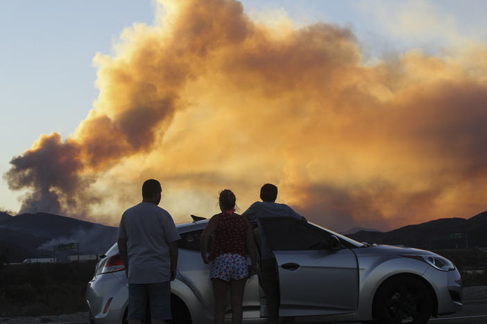 People watch the Blue Cut Fire in Lytle Creek, Calif., in 2016.
