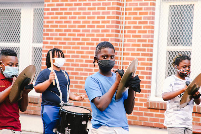 Students rehearse outdoors at The Roots of Music. The education nonprofit has kept its marching band going throughout the pandemic and resumed in-person rehearsal over the summer.