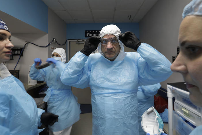 Dr. Joseph Varon prepares to enter the COVID-19 unit at Houston's United Memorial Medical Center in May. With him are nurses Tanna Ingraham (left) and Jerusha Harshman (right).