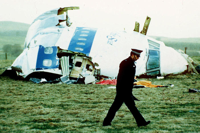 A police officer walks on Dec. 21, 1988, by the nose of Pan Am Flight 103 near Lockerbie, Scotland, where it lay after a bomb aboard exploded, killing a total of 270 people.