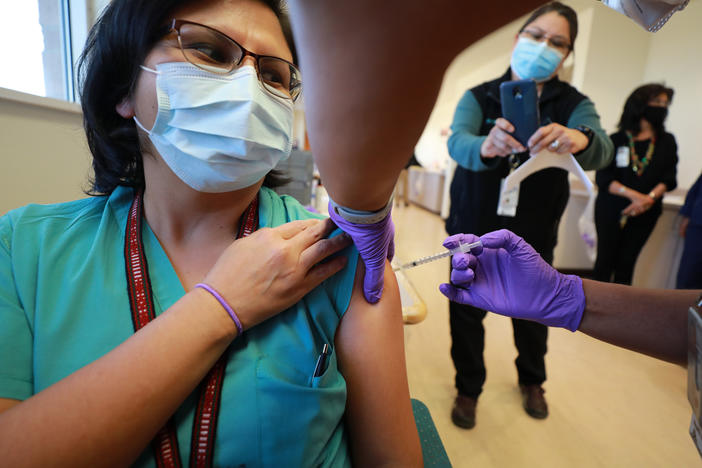 Dr. Lawanda Jim, Chair of Internal Medicine, receives a COVID-19 vaccine at Northern Navajo Medical Center on Tuesday in Shiprock, N.M.