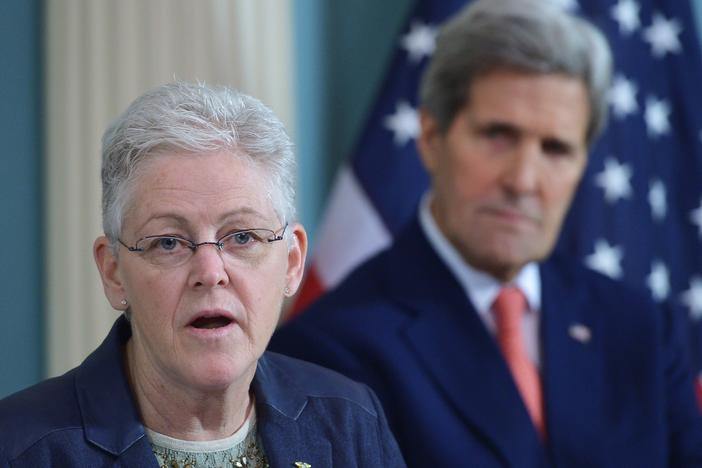 Then-Environmental Protection Agency Administrator Gina McCarthy speaks during a 2015 signing ceremony for an air quality agreement as then-Secretary of State John Kerry looks on. The two will be back together working on climate issues in the Biden administration.