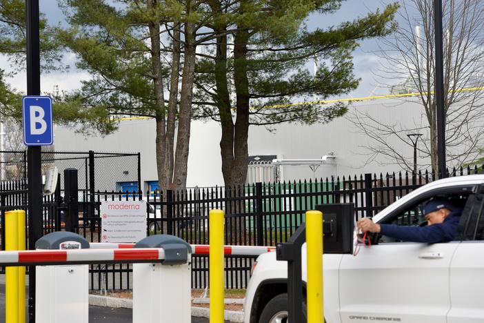 A worker passes through the security gate at the Moderna campus in Norwood, Mass., one of the sites where the biotechnology company is manufacturing its COVID-19 vaccine.