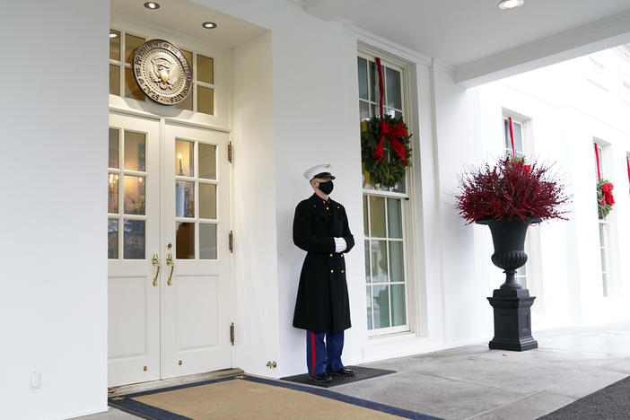A Marine stands outside the West Wing of the White House last week. President Trump has been lobbied by advocates to use his powers to grant pardons and commutations ahead of leaving office.