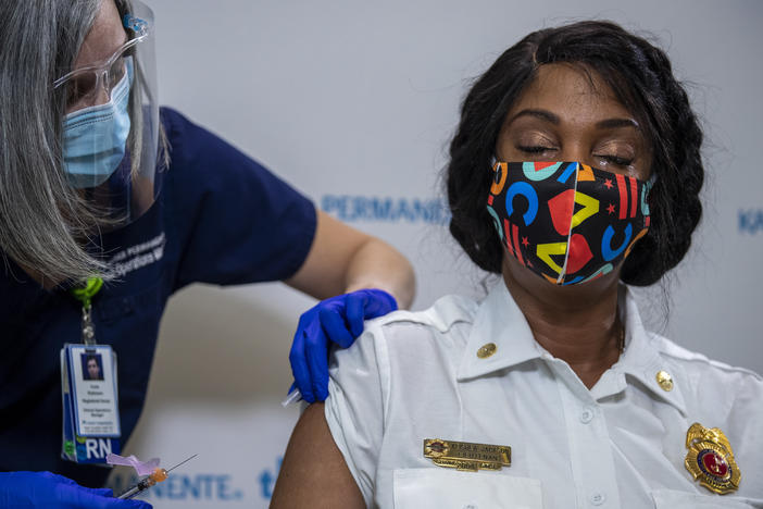 Washington, D.C., Fire and EMS Lt. Keishea Jackson gets a Pfizer coronavirus vaccine shot on Thursday.