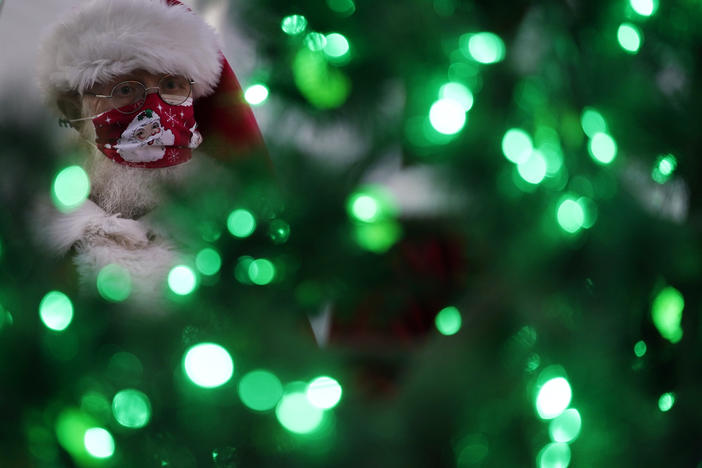 Bill Sandeen, dressed as Santa Claus, waits for the opening of a Santa drive-through selfie station in Las Vegas on Dec. 10. The real Santa was vaccinated by Dr. Anthony Fauci at the North Pole.