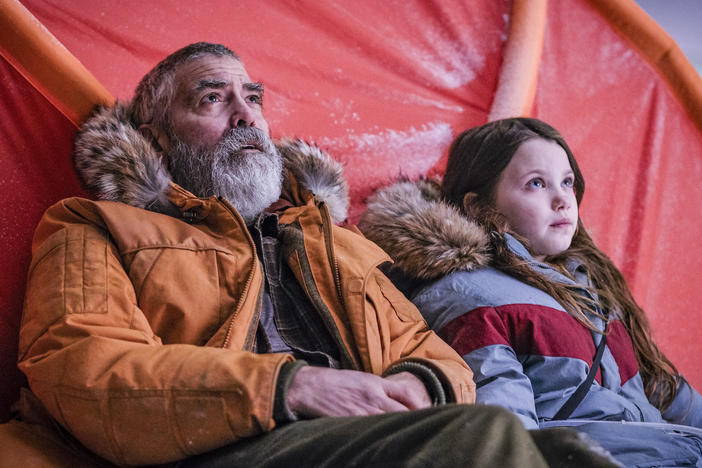 George Clooney and Caoilinn Springall, right, in a scene from the sci-fi film Clooney directed, <em>The Midnight Sky.</em>