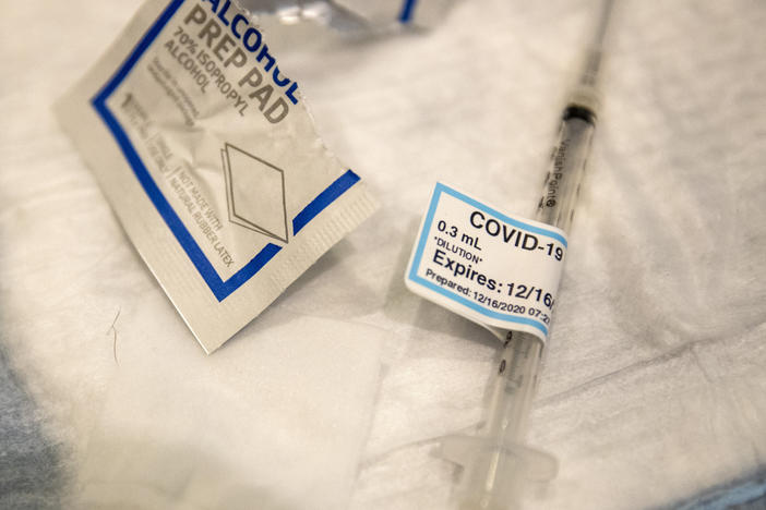 An empty syringe on a table at Ronald Reagan UCLA Medical Center after a care worker received the COVID-19 vaccine on Dec. 16, 2020.