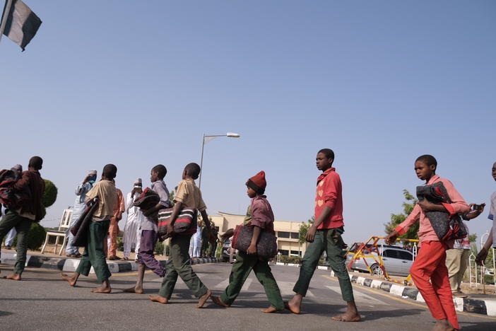 Released students from the Government Science Secondary school in Kankara, in Nigeria's northwestern Katsina State, are led into the Government House upon their release on Friday.