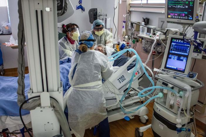 Physicians and nurses wear personal protective equipment while they attend to a COVID-19 patient in the ICU at Providence Cedars-Sinai Tarzana Medical Center in Tarzana, Calif. on December 18, 2020.