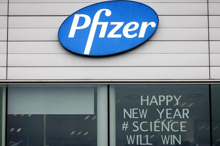 A sign appears in the window of an office at Pfizer Manufacturing in Puurs, Belgium, on Monday, the same day the European Medicines Agency authorized the use of the company's COVID-19 vaccine.