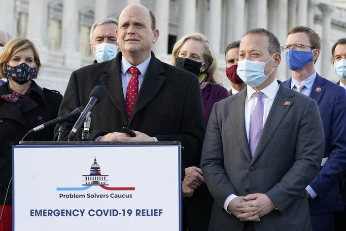 Members of the bipartisan Problem Solvers Caucus — co-chairs Rep. Tom Reed, R-N.Y., at lectern, and Rep. Josh Gottheimer, D-N.J., to his right — took credit for helping to break the logjam on an emergency COVID-19 relief bill.