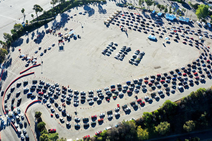 Cars are lined up at Dodger Stadium in Los Angeles for coronavirus testing. Nearly 2 million people are getting tested a day in the U.S. A new analysis shows millions more are needed to protect the most vulnerable.