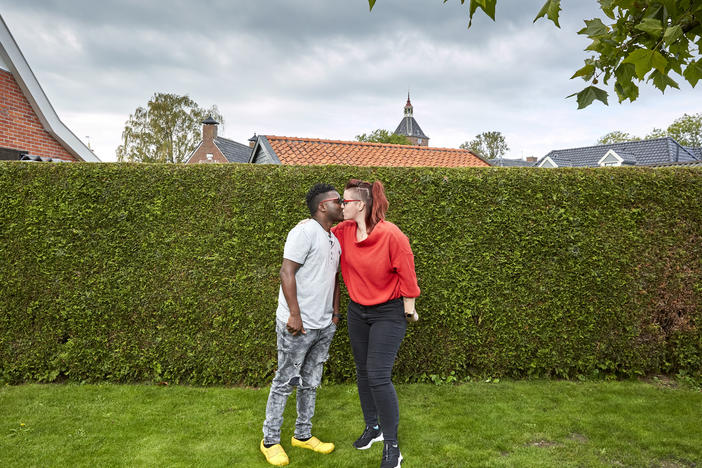 Patrick Phiri of Malawi and fiance Fiona ten Have of Holland kiss in her parents' garden. The couple met in Malawi, where they worked for the same charity, and fell in love. A 3-week visit to the Netherlands turned into 7 months due to pandemic lockdowns and travel restrictions.