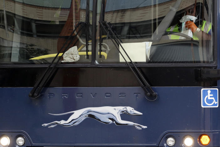 A Greyhound bus driver wears a protective mask and gloves as he prepares to depart a station in San Antonio, Texas, on March 30. Bus companies are struggling amid the pandemic, cutting off travel options for lower-income Americans.
