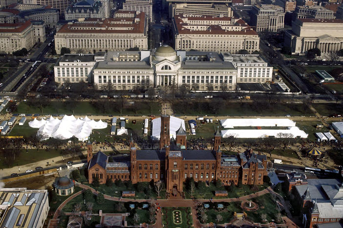 An aerial view of the National Mall in Washington, D.C., with the Smithsonian Institution Building ("The Castle") in the foreground and the Smithsonian's National Museum of Natural History in the background.