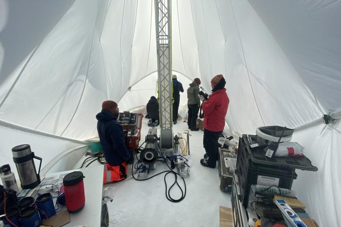 Inside of the Blue Ice Drill tent, drillers Tanner Kuhl (left) and Elizabeth Morton (right) work with graduate students Austin Carter, Jacob Morgan and postdoctoral fellow Sarah Shackleton in Antarctica in 2019.