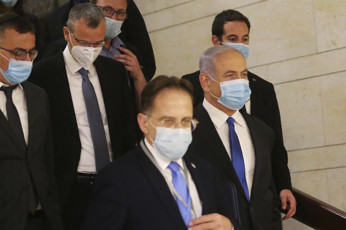 Israeli Prime Minister Benjamin Netanyahu (center) wears a protective face mask as he makes his way to attend the swearing-in ceremony of his new government, at the Knesset, Israel's parliament, in May. The Knesset has dissolved and Israel is headed to new elections for the fourth time in two years.