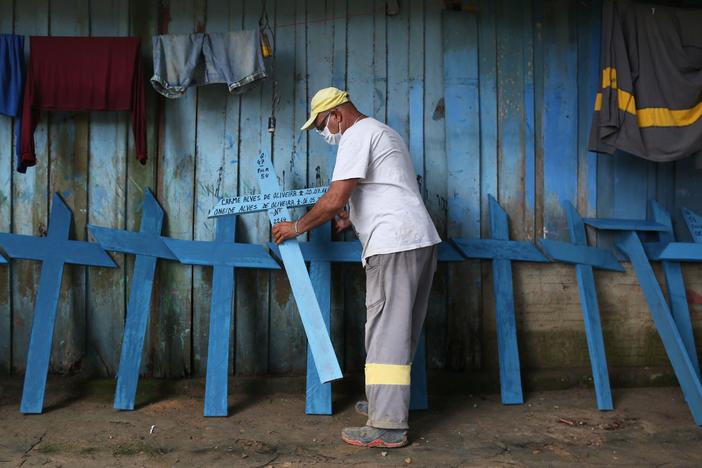 Ulisses Xavier, 52, who has worked for 16 years at Nossa Senhora cemetery in Manaus, Brazil, makes wooden crosses to supplement his income. The cemetery has seen a surge in the number of new graves after the outbreak of COVID-19.