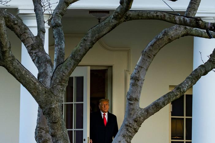 President Trump emerges from the Oval Office on Wednesday as he departs the White House en route to Florida's Mar-a-Lago, where he will spend Christmas and New Year's Eve.