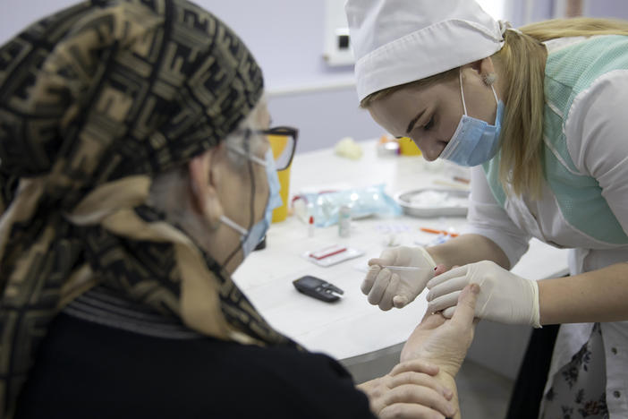 A woman undergoes antibody testing before an injection of the Russian COVID-19 vaccine known as Sputnik V at an outpatient clinic in Grozny earlier this week.
