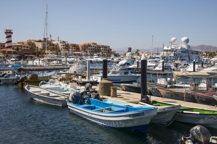 Many Americans are visiting Mexico's beaches during the pandemic. Above, fishing boats are docked at a marina in Los Cabos, Mexico, on June 2.