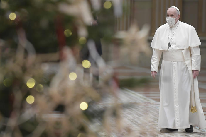 Pope Francis arrives to deliver his Christmas Day message, Urbi et Orbi, in the Apostolic Palace in Vatican City.