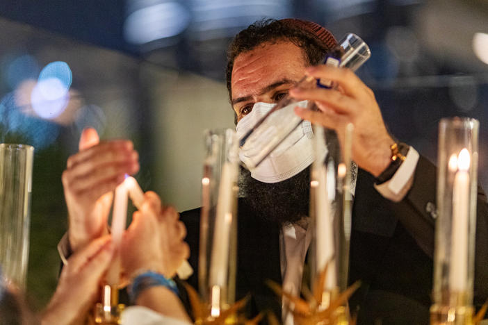 Rabbi Levi Duchman lights a menorah during Hanukkah at a private residence in Dubai, United Arab Emirates, in December.