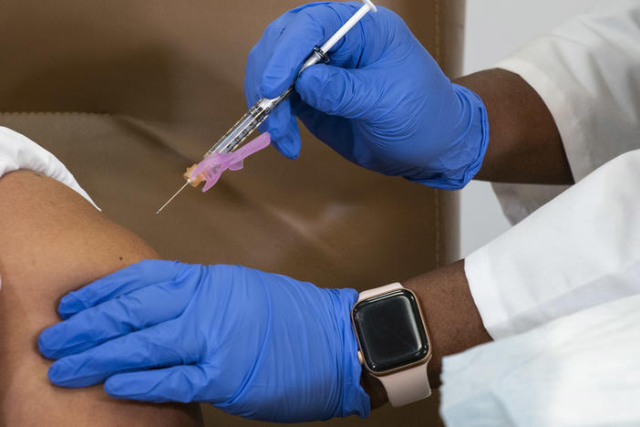 Arlene Ramirez receives the Moderna COVID-19 vaccine last week at Northwell Health's Long Island Jewish Valley Stream hospital in New York. Health care workers across the country have started receiving COVID-19 vaccines, but doctors and nurses at some hospitals say vaccine distribution has been chaotic.