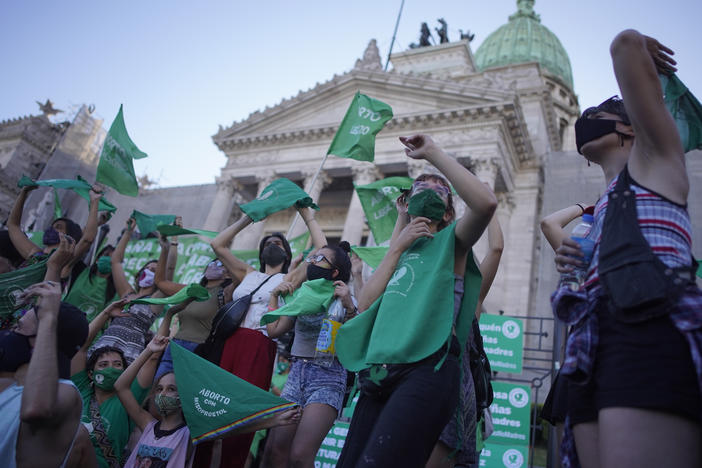 Abortion-rights activists in favor of a bill legalizing abortion gather outside the legislative building in Buenos Aires, Argentina, on Thursday.