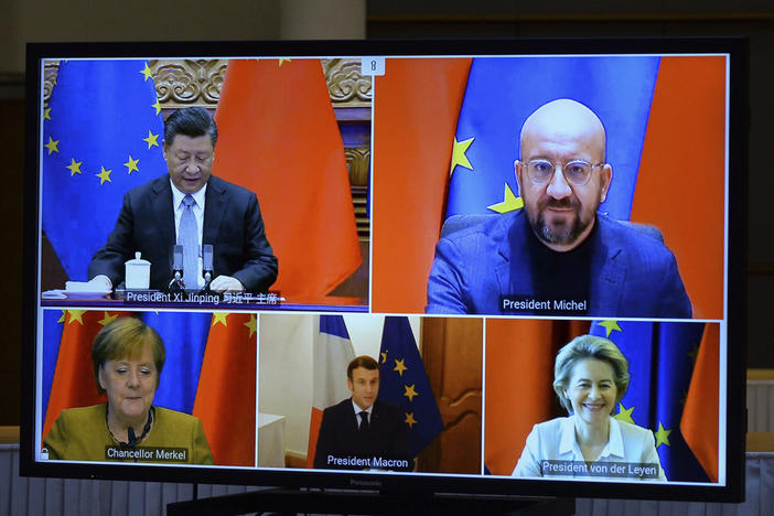 A screen displays Chinese President Xi Jinping (top left), European Council President Charles Michel (top right), European Commission President Ursula von der Leyen (bottom right), French President Emmanuel Macron and German Chancellor Angela Merkel during an EU-China Leaders' meeting video conference Wednesday.