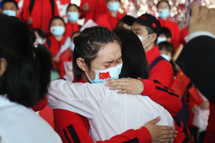 Health workers from Tongji Hospital in Wuhan, China, share an emotional embrace with their peers from a hospital in Jilin province at the Tianhe Airport. Colleagues who worked on the front lines together bid farewell as Wuhan lifted its coronavirus lockdown in April.