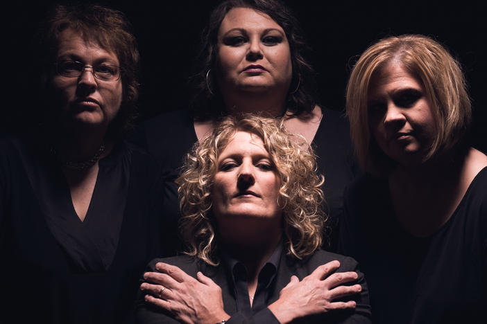 Dale Ann Bradley (left), Tina Adair, Gena Britt and Deanie Richardson (center) of the bluegrass band Sister Sadie do their impression of the rock band Queen.